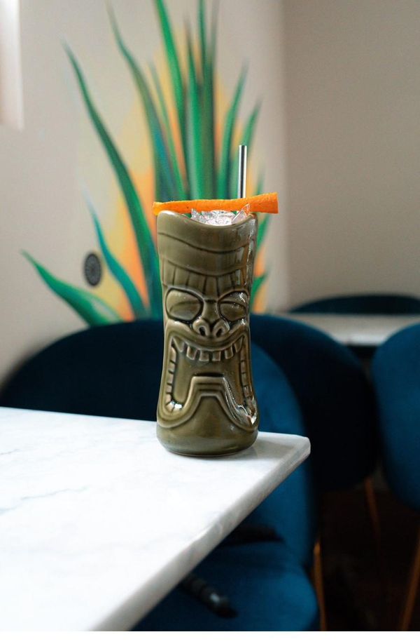 Tiki mug cocktail with orange peel garnish